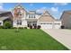 Beautiful two-story home with a well-manicured lawn and three car garage at 16264 Red Clover Ln, Noblesville, IN 46062