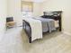 Cozy bedroom with neutral carpet, a dark wood bed frame, and ample natural light from a window at 1645 Woodview Ln, Anderson, IN 46011