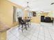 Bright dining area with tile floors, a chandelier, and views into the living room at 1645 Woodview Ln, Anderson, IN 46011