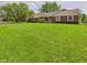 Expansive front yard with lush green grass and a well-maintained house at 1645 Woodview Ln, Anderson, IN 46011