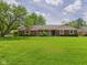 Charming home with a well-manicured front yard and mature trees, offering curb appeal at 1645 Woodview Ln, Anderson, IN 46011