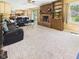 Inviting living room features carpet, a fireplace, built-in shelving, and a view of the kitchen and sliding doors at 1645 Woodview Ln, Anderson, IN 46011