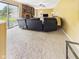 Bright and open living room with carpet, fireplace, access to the backyard, and a comfortable seating arrangement at 1645 Woodview Ln, Anderson, IN 46011