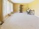 Versatile office space with carpet, large windows, a desk, and a modern shelving unit at 1645 Woodview Ln, Anderson, IN 46011