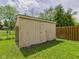 Storage shed in backyard with access door and fenced in area at 1645 Woodview Ln, Anderson, IN 46011