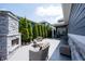 Inviting backyard with stone fireplace, wicker furniture, and privacy landscaping at 1648 Rossmay Dr, Westfield, IN 46074