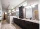 A spacious bathroom featuring a double vanity, granite countertops, and a glass-enclosed shower with decorative stone accents at 1648 Rossmay Dr, Westfield, IN 46074