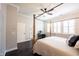 Well-lit bedroom featuring a four-poster bed, complemented by natural light and a ceiling fan at 1648 Rossmay Dr, Westfield, IN 46074