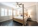 Serene bedroom with a four-poster bed, complemented by natural light and a ceiling fan at 1648 Rossmay Dr, Westfield, IN 46074