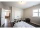 Comfortable bedroom featuring wood floors, a metal frame bed, ample closet space, and natural light from the window at 1648 Rossmay Dr, Westfield, IN 46074