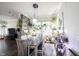 Bright dining room with natural light, stylish hanging lights, and abundant indoor plants and greenery at 1648 Rossmay Dr, Westfield, IN 46074