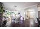 Elegant dining room with a stone accent wall, pendant lighting, and a view of lush indoor greenery at 1648 Rossmay Dr, Westfield, IN 46074