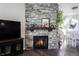 Stone fireplace with a wood mantle and gas logs at 1648 Rossmay Dr, Westfield, IN 46074