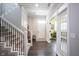 Bright foyer with hardwood floors, staircase with decorative railing, and elegant French doors to the workout room at 1648 Rossmay Dr, Westfield, IN 46074