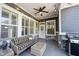 Charming outdoor patio with ceiling fan, string lights, and stylish wicker furniture at 1648 Rossmay Dr, Westfield, IN 46074