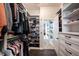 Well-designed walk-in closet with custom organizers, shelves, and hanging space, connecting to a luxurious bathroom at 1648 Rossmay Dr, Westfield, IN 46074
