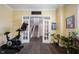 Spacious workout room with motivational decor and access to the rest of the home via French doors at 1648 Rossmay Dr, Westfield, IN 46074