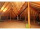 Spacious attic with wood beams and plywood flooring offers potential for storage or conversion at 17003 Whitebark Ct, Westfield, IN 46074