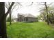 Manicured backyard with sprawling green grass and the home's rear elevation at 17003 Whitebark Ct, Westfield, IN 46074