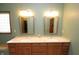 Bathroom featuring a double vanity with stylish mirrors and a window seat at 17003 Whitebark Ct, Westfield, IN 46074