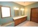 Bathroom features a double sink vanity, framed mirrors, and a window providing natural light at 17003 Whitebark Ct, Westfield, IN 46074