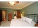 Spacious bedroom featuring a comfortable bed, stylish nightstands, and a sliding barn door at 17003 Whitebark Ct, Westfield, IN 46074