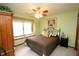 Cozy bedroom with a window seat, ceiling fan, and green walls at 17003 Whitebark Ct, Westfield, IN 46074