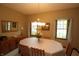 Charming dining area with a classic chandelier, wood furniture, and ample natural light from the windows at 17003 Whitebark Ct, Westfield, IN 46074