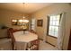Traditional dining room with a decorative chandelier, large table, and bright windows at 17003 Whitebark Ct, Westfield, IN 46074