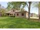 Exterior view of well-maintained lawn and charming brick house with bright red shutters at 17003 Whitebark Ct, Westfield, IN 46074