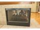 Close up of the modern fireplace with black trim and metal mesh fire screen at 17003 Whitebark Ct, Westfield, IN 46074