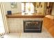 Cozy fireplace with tiled surround and a wooden mantle, blending warmth and style in the home at 17003 Whitebark Ct, Westfield, IN 46074