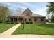Charming brick home featuring a well-manicured lawn, red shutters, and a welcoming front porch at 17003 Whitebark Ct, Westfield, IN 46074