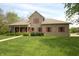 Charming brick home featuring a well-manicured lawn, red shutters, and a welcoming front porch at 17003 Whitebark Ct, Westfield, IN 46074