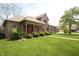 Charming brick home featuring a well-manicured lawn, red shutters, and a welcoming front porch at 17003 Whitebark Ct, Westfield, IN 46074