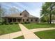 Charming brick home featuring a well-manicured lawn, red shutters, and a welcoming front porch at 17003 Whitebark Ct, Westfield, IN 46074