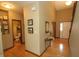 Entry hallway boasts hardwood floors, neutral paint, and framed art, leading to other rooms at 17003 Whitebark Ct, Westfield, IN 46074
