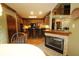 Kitchen featuring wood cabinets, black appliances, and views of the fireplace and breakfast bar at 17003 Whitebark Ct, Westfield, IN 46074