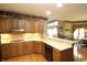 This kitchen showcases wood cabinets, light countertops, and stainless appliances, blending style with functionality at 17003 Whitebark Ct, Westfield, IN 46074
