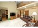 Inviting living room with high ceilings, fireplace, plush seating, and hardwood floors at 17003 Whitebark Ct, Westfield, IN 46074