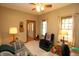 Comfortable living room featuring a plaid sofa, arm chair, and light-filled windows with neutral curtains at 17003 Whitebark Ct, Westfield, IN 46074