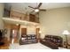 Open-concept living room featuring soaring ceilings, a loft, and comfortable leather seating at 17003 Whitebark Ct, Westfield, IN 46074