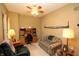 Inviting living room with a cozy plaid couch and a functional workspace with a desk and shelves at 17003 Whitebark Ct, Westfield, IN 46074