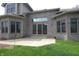 Rear exterior featuring brick, large windows, and a stone patio at 17003 Whitebark Ct, Westfield, IN 46074