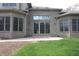 Rear exterior featuring brick, large windows, and a stone patio at 17003 Whitebark Ct, Westfield, IN 46074