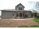 A view of the home's rear elevation with brick, a walkout patio, and a landscaped yard at 17003 Whitebark Ct, Westfield, IN 46074