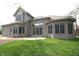 Rear exterior of house featuring brick, large windows, and patio space at 17003 Whitebark Ct, Westfield, IN 46074