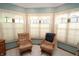 Bright sitting area with natural light from large windows and comfortable chairs at 17003 Whitebark Ct, Westfield, IN 46074