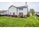 Expansive backyard with lush green lawn, featuring a deck ideal for outdoor entertaining at 1831 Whisperwood Trl, Danville, IN 46122