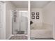 Bright bathroom with a soaking tub, shower with glass doors, and decor art at 1831 Whisperwood Trl, Danville, IN 46122